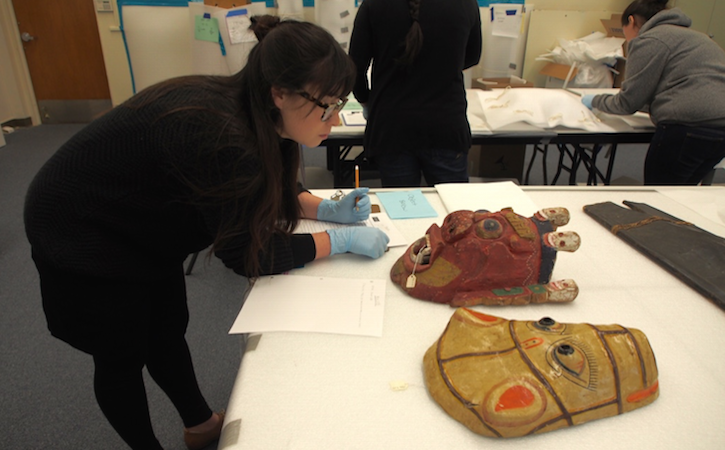 Student in Museum Studies with artifacts