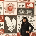 Liz Hernández standing in front her mural at the San Francisco Museum of Modern Art